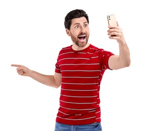 Photo of Emotional man taking selfie with smartphone on white background