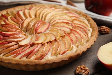 Photo of Delicious homemade apple tart on wooden table, closeup