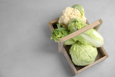 Basket with tasty cabbages on grey table