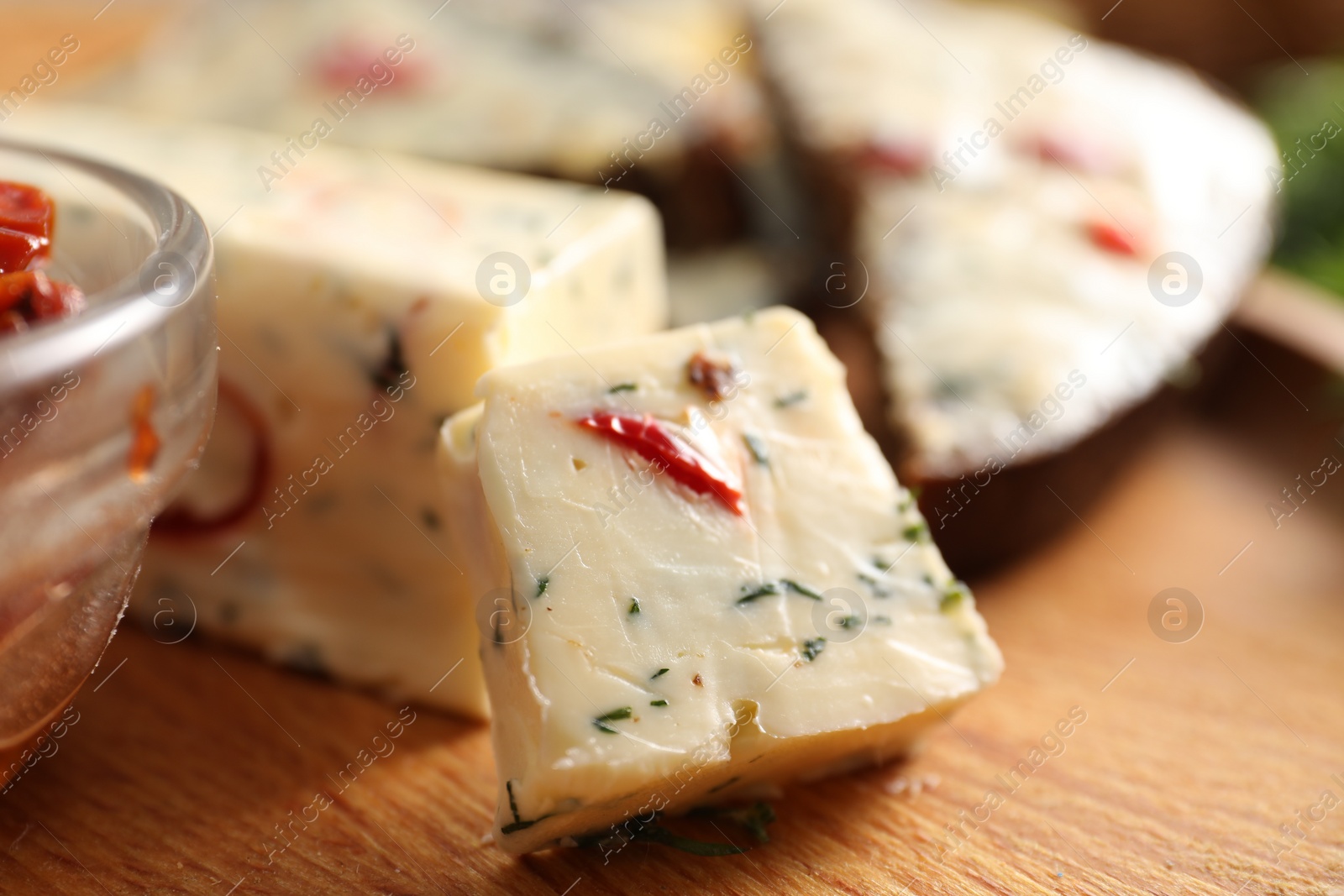 Photo of Tasty butter with dill and chili pepper on wooden plate, closeup