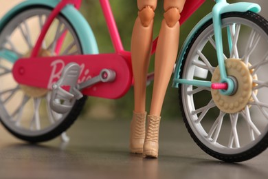 Mykolaiv, Ukraine - September 4, 2023: Barbie doll with bicycle on blurred background, closeup