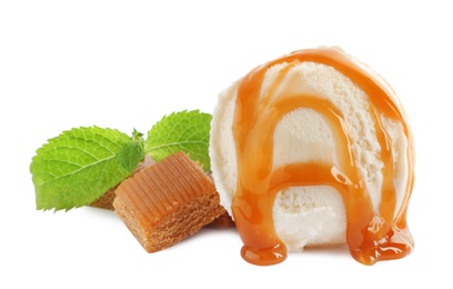 Delicious ice cream with caramel sauce, candies and mint on white background