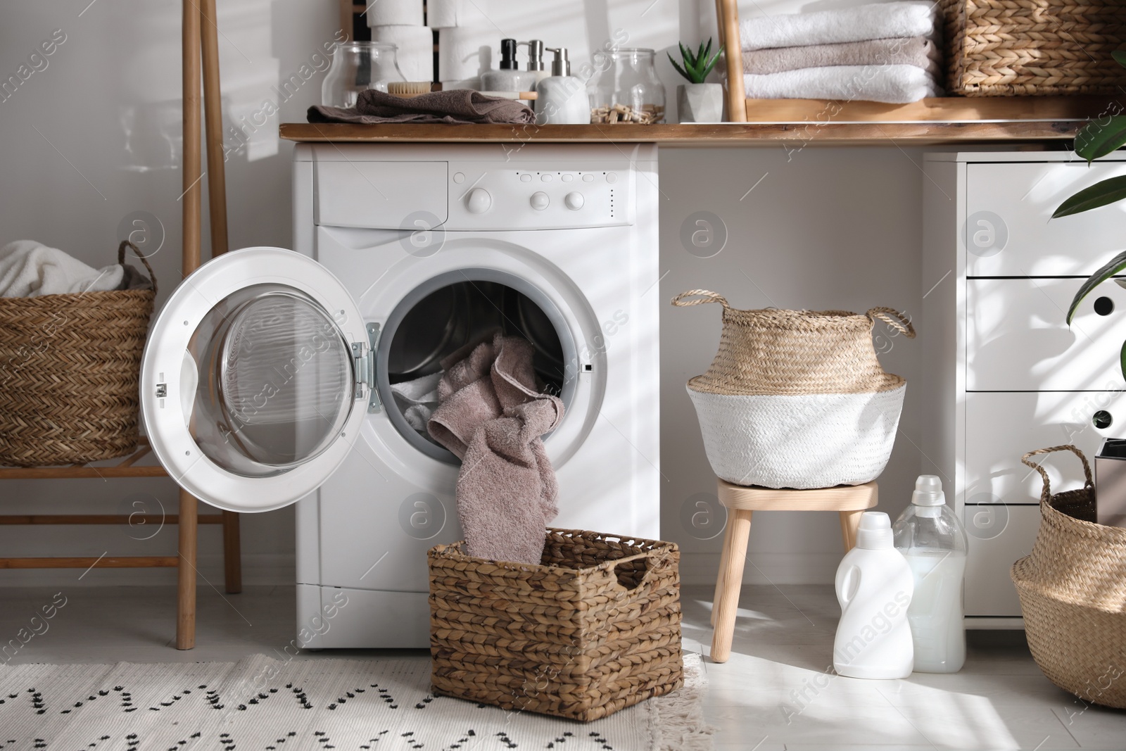 Photo of Stylish bathroom interior with modern washing machine