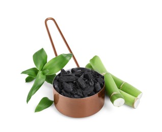 Photo of Fresh bamboo and charcoal on white background