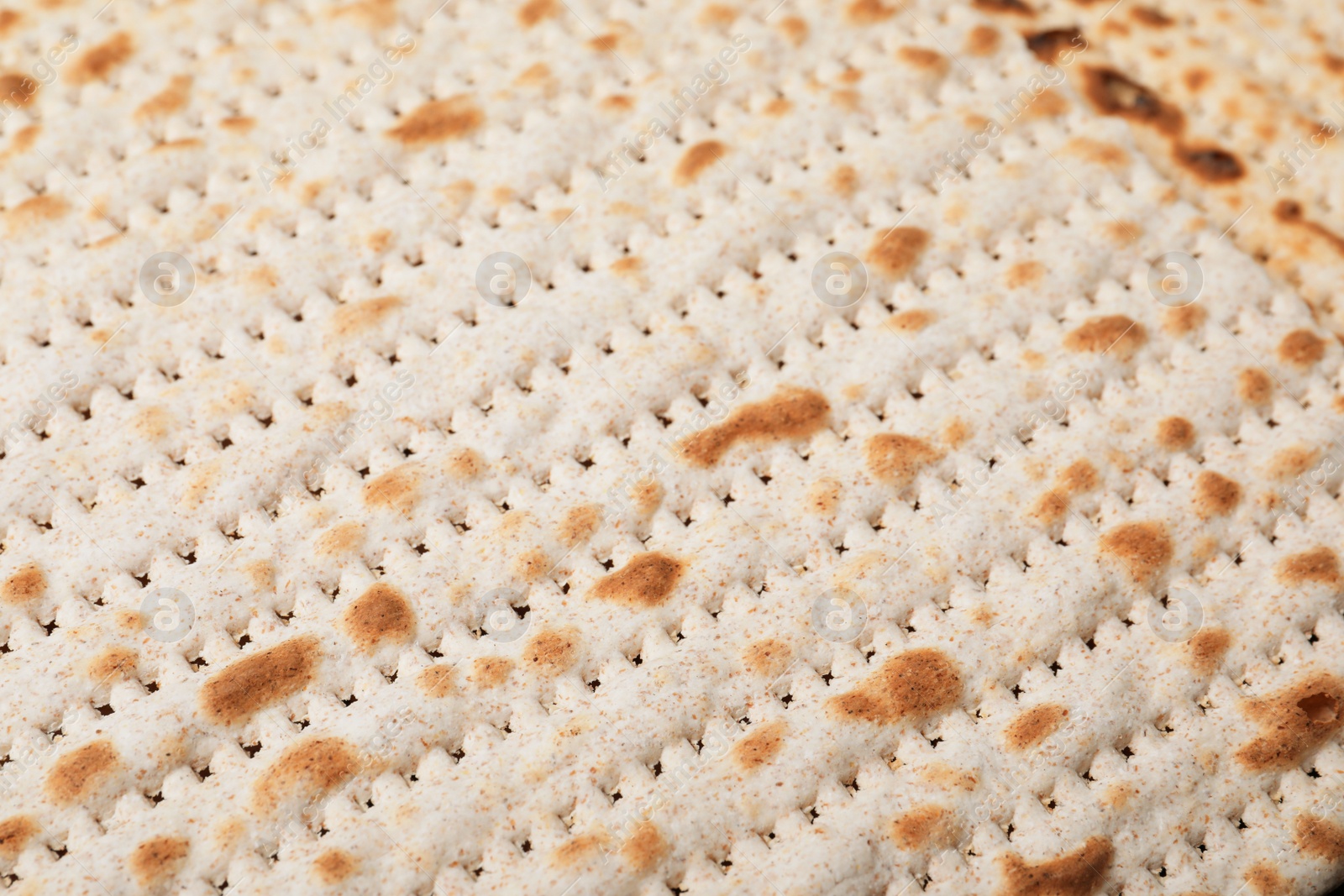 Photo of Traditional matzo as background, closeup. Pesach celebration