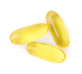 Many yellow vitamin capsules isolated on white, top view