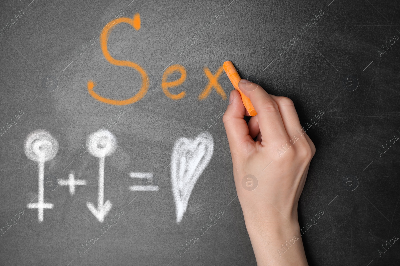 Image of Sexual education. Woman writing word Sex on black chalkboard, closeup. Chalked equation with heart, female and male gender signs