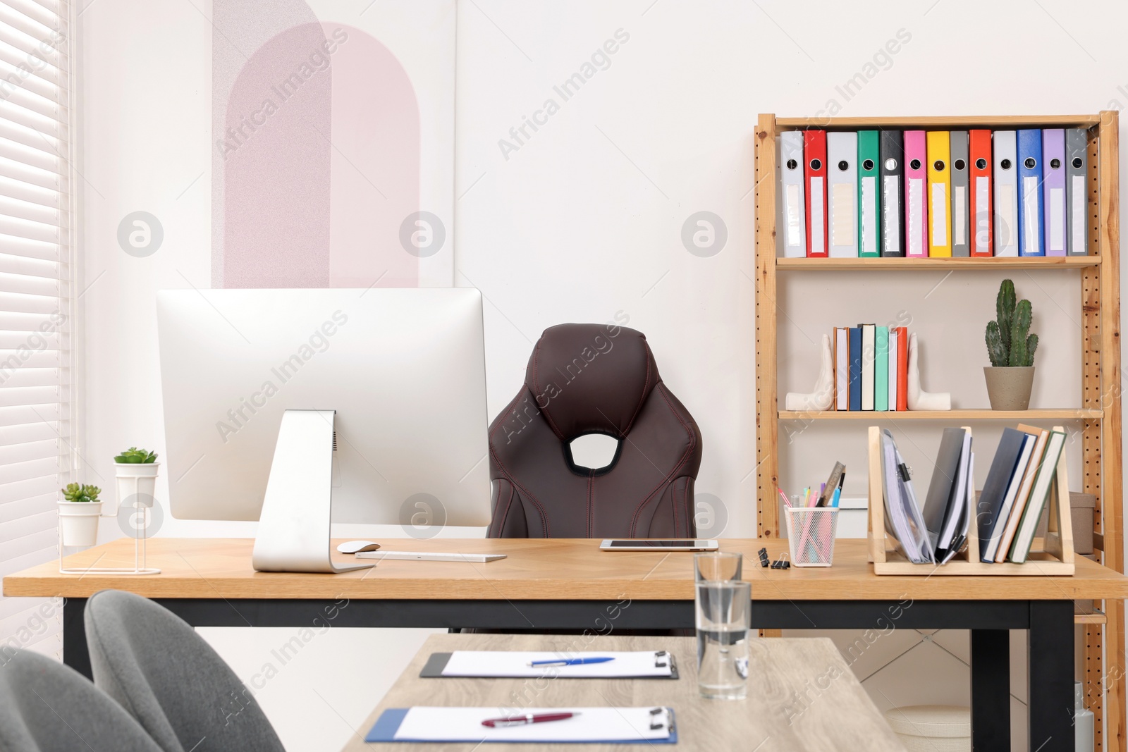 Photo of Director's office with large wooden table and comfortable armchairs. Interior design