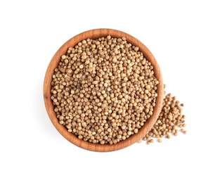 Dried coriander seeds in wooden bowl on white background, top view