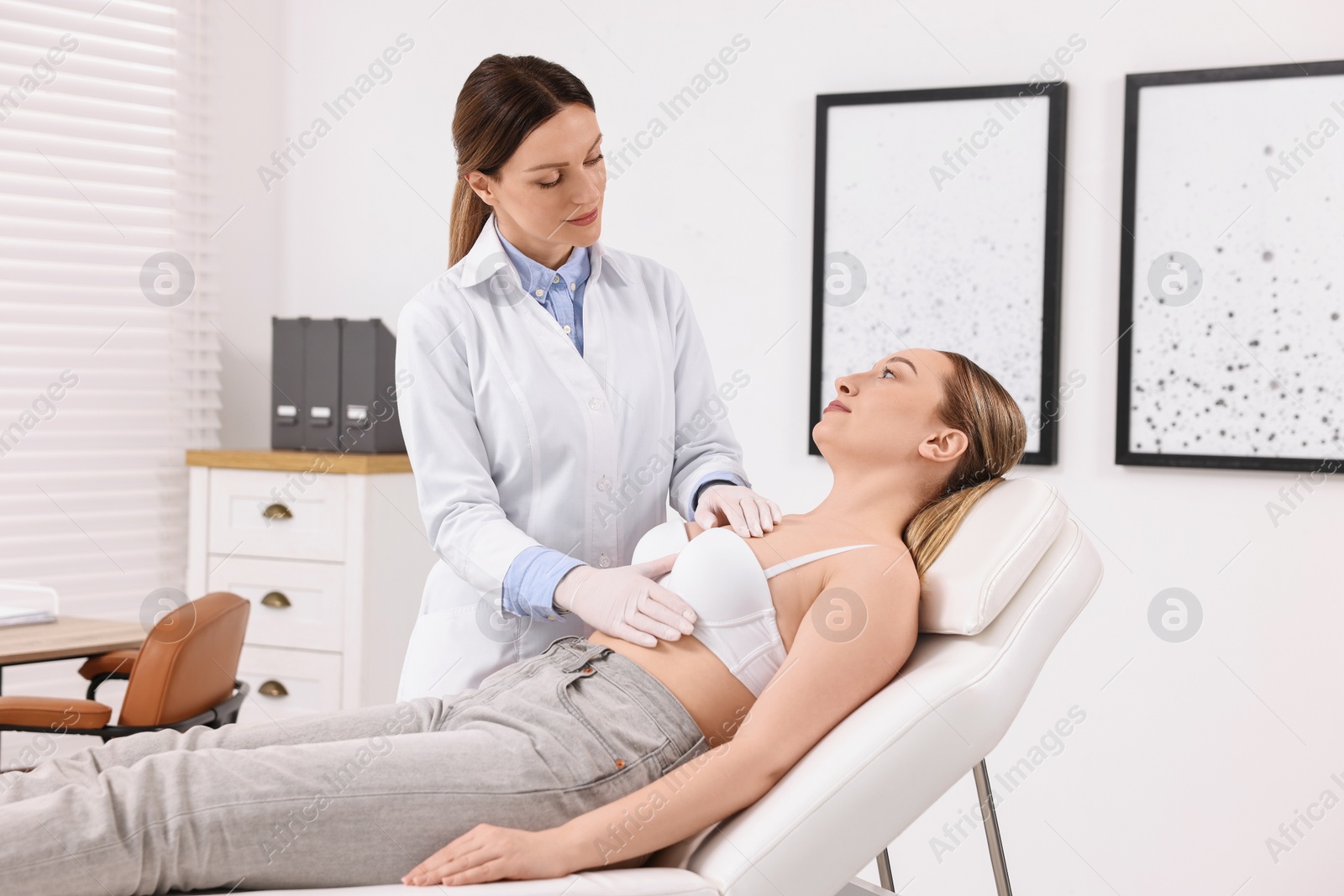 Photo of Mammologist checking young woman's breast in hospital