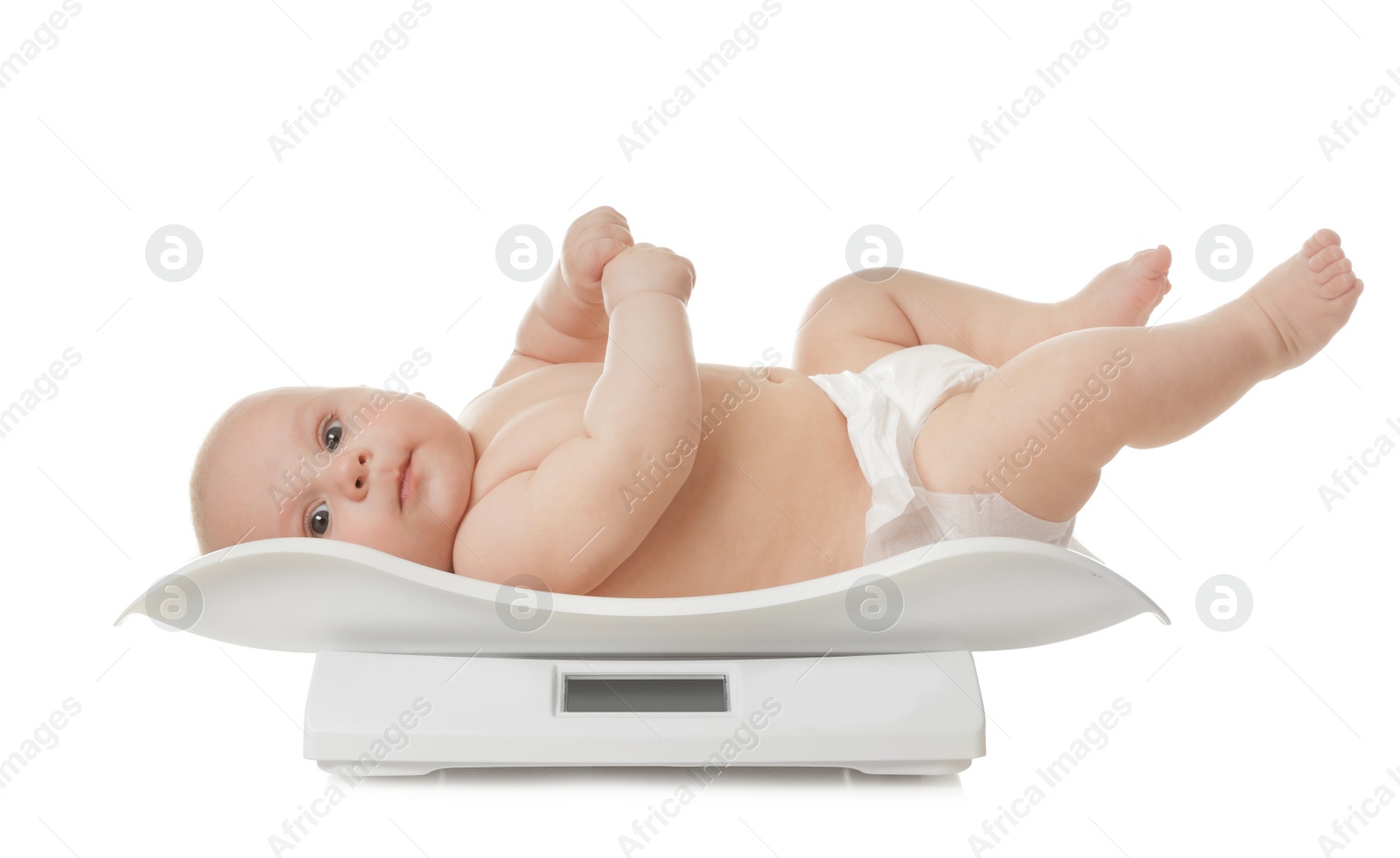 Photo of Cute little baby lying on scales against white background