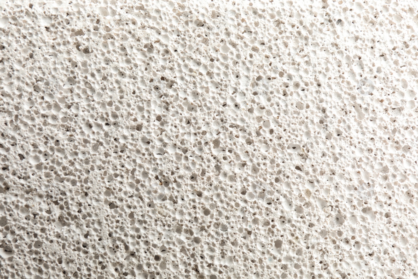 Photo of Texture of white pumice stone as background, closeup