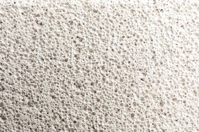 Photo of Texture of white pumice stone as background, closeup