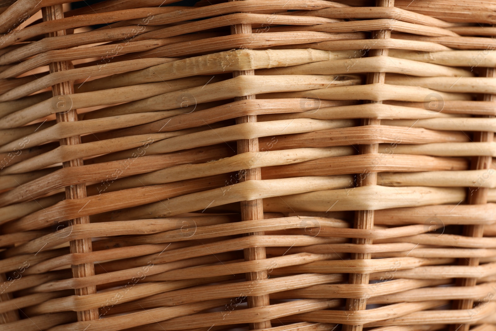 Photo of Handmade wicker basket made of natural material as background, closeup view
