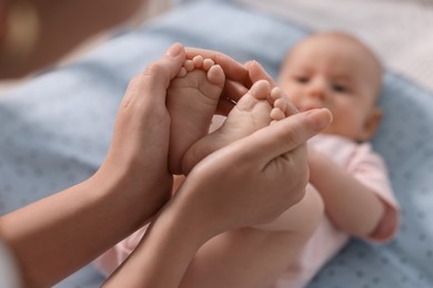 Mother with her cute little baby in crib, selective focus