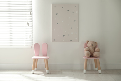 Cute chairs with bunny ears in children's room interior