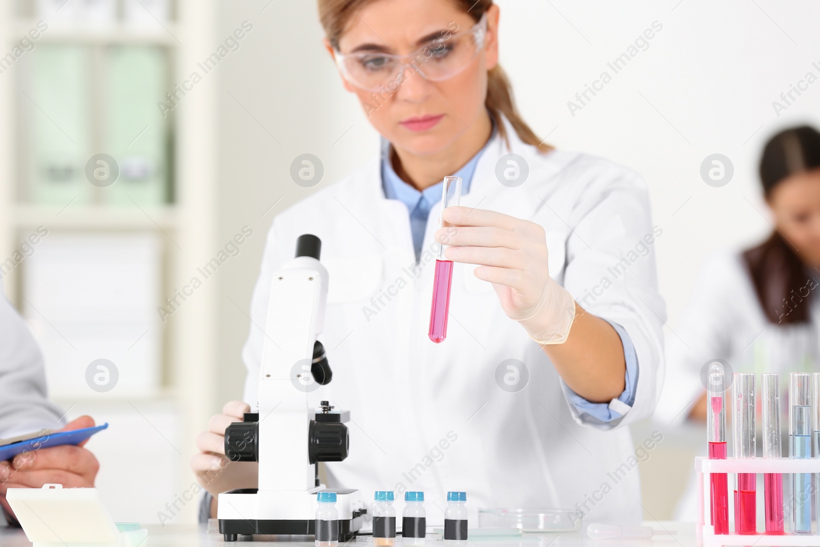 Photo of Female scientist working at table in laboratory. Research and analysis