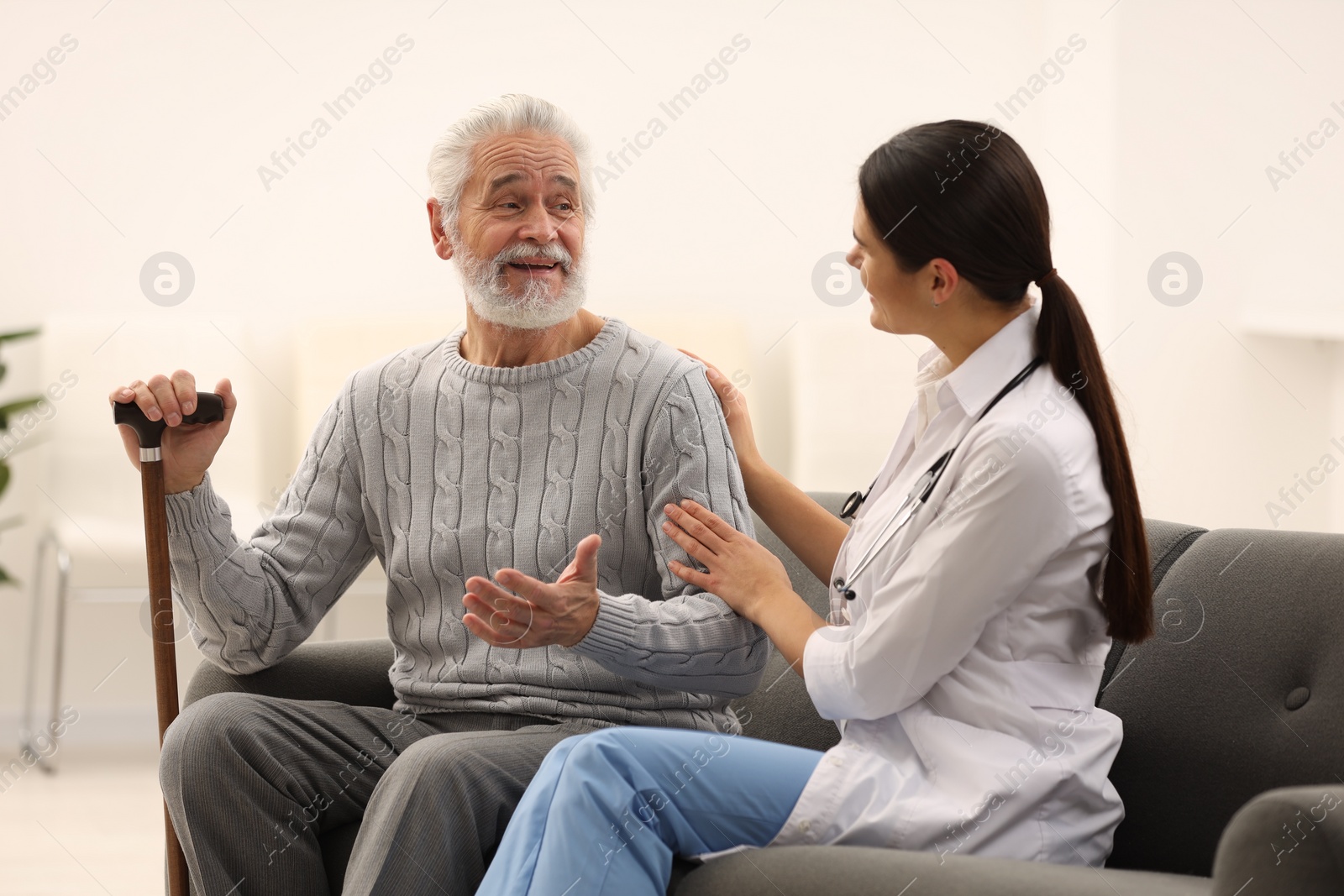 Photo of Health care and support. Nurse listening to elderly patient in hospital