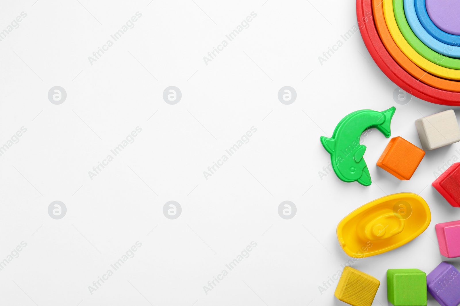 Photo of Different children's toys on white background, flat lay. Space for text