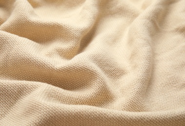 Photo of Soft warm beige plaid as background, closeup