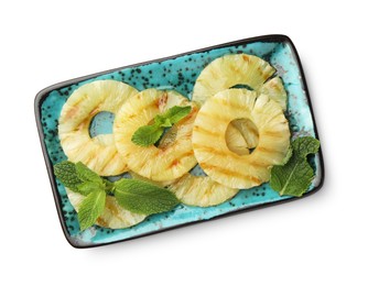 Tasty grilled pineapple slices and mint isolated on white, top view
