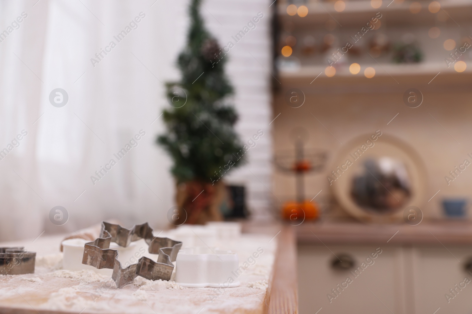 Photo of Cookie cutter on wooden table in kitchen, space for text