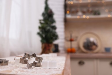 Cookie cutter on wooden table in kitchen, space for text