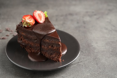 Photo of Delicious fresh chocolate cake with strawberry on grey table