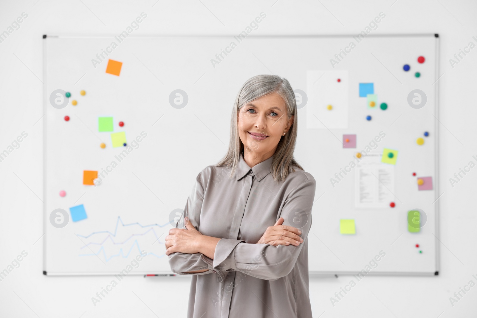 Photo of Portrait of happy professor near whiteboard indoors