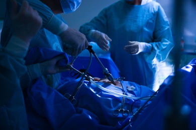 Medical team performing surgery in operating room, closeup