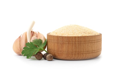 Bowl of dry garlic powder and parsley on white background