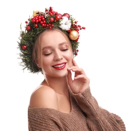 Photo of Beautiful young woman wearing Christmas wreath on white background