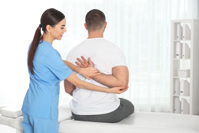 Photo of Doctor working with patient in hospital. Rehabilitation physiotherapy