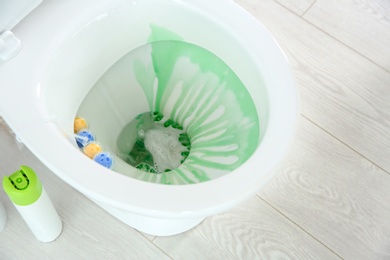 Photo of Ceramic toilet bowl with detergent in modern bathroom