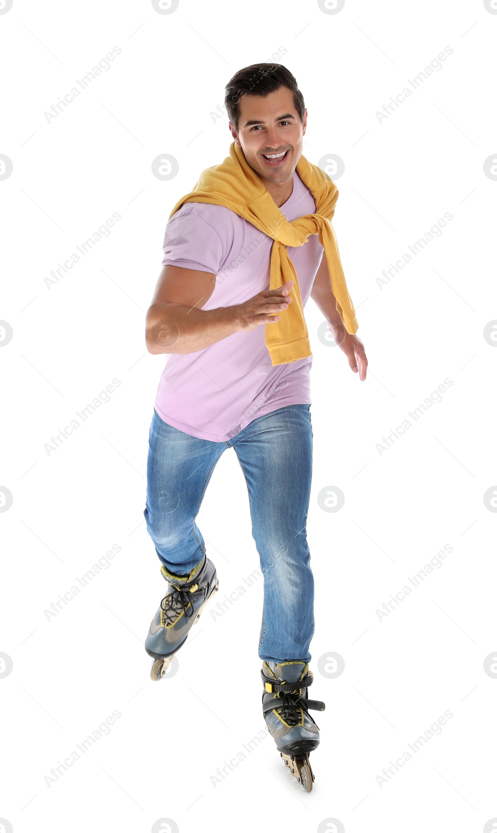 Photo of Handsome young man with inline roller skates on white background