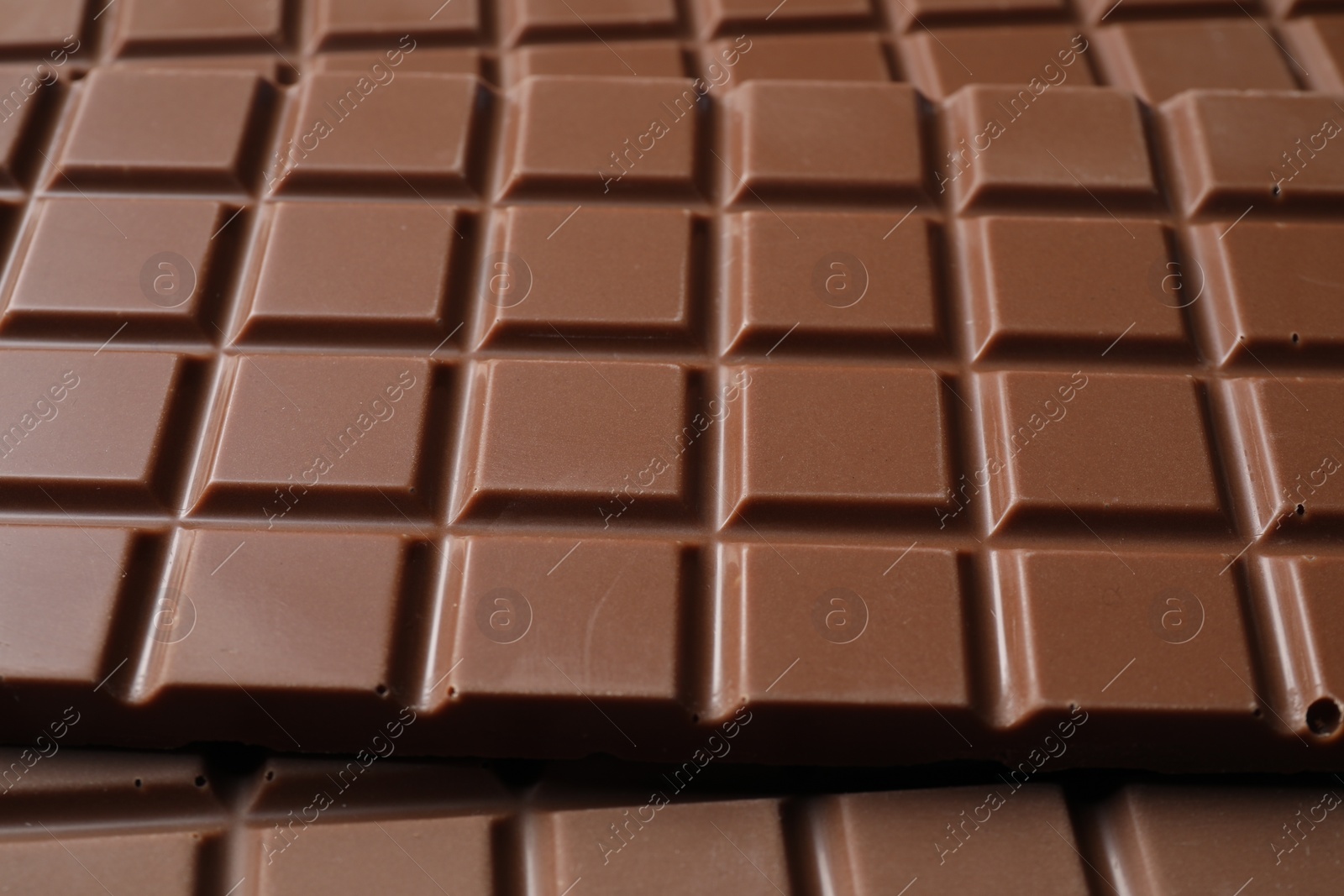 Photo of Delicious milk chocolate bars as background, closeup