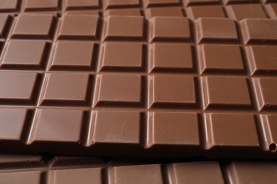 Photo of Delicious milk chocolate bars as background, closeup