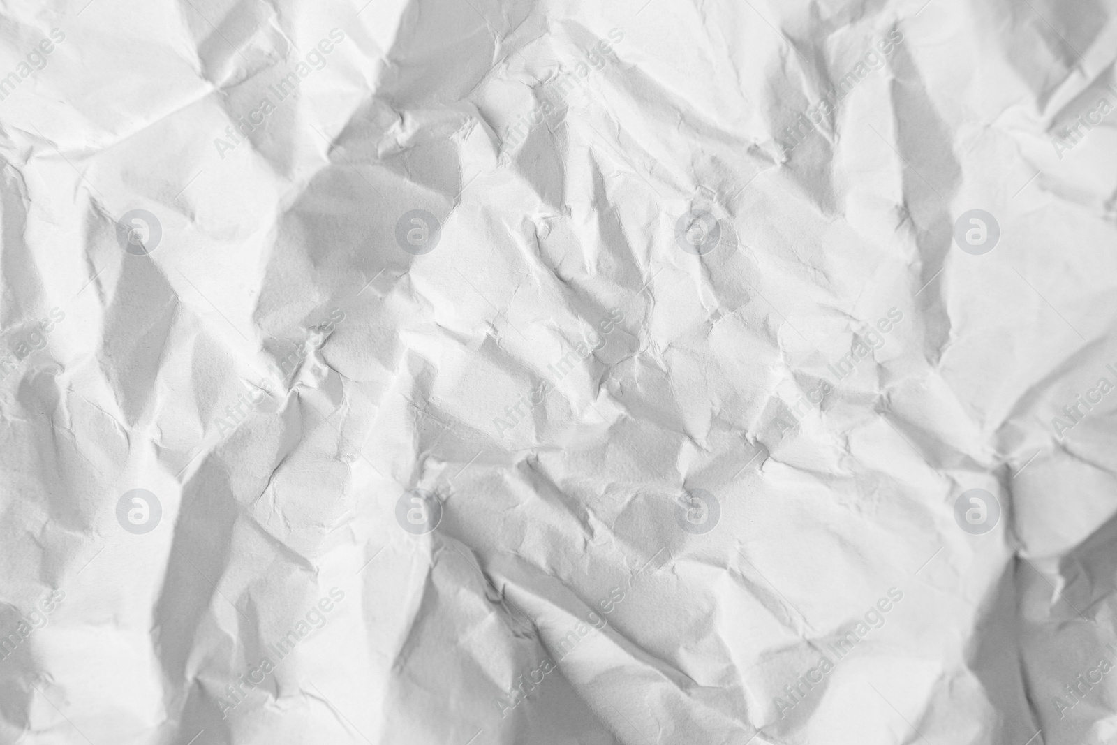 Photo of Sheet of crumpled paper white as background, top view