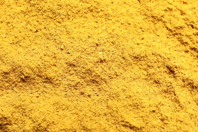 Photo of Dry curry powder as background, top view