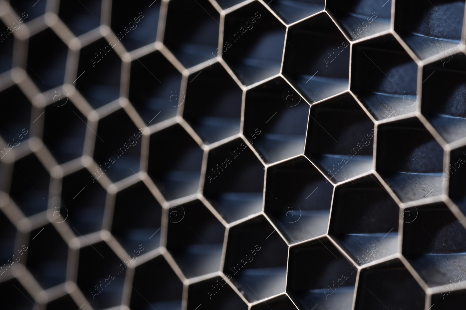 Photo of Texture of honeycomb grid for reflector as background, macro view