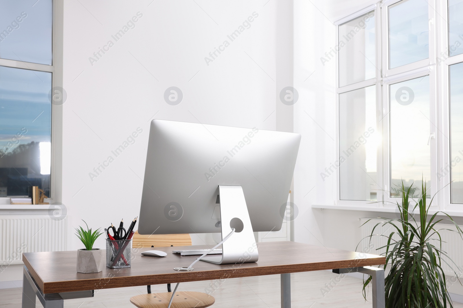 Photo of Comfortable workplace in stylish room. Home office