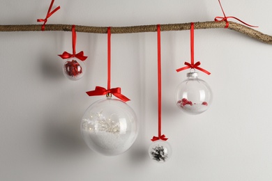 Photo of Decorative snow globes hanging on grey background