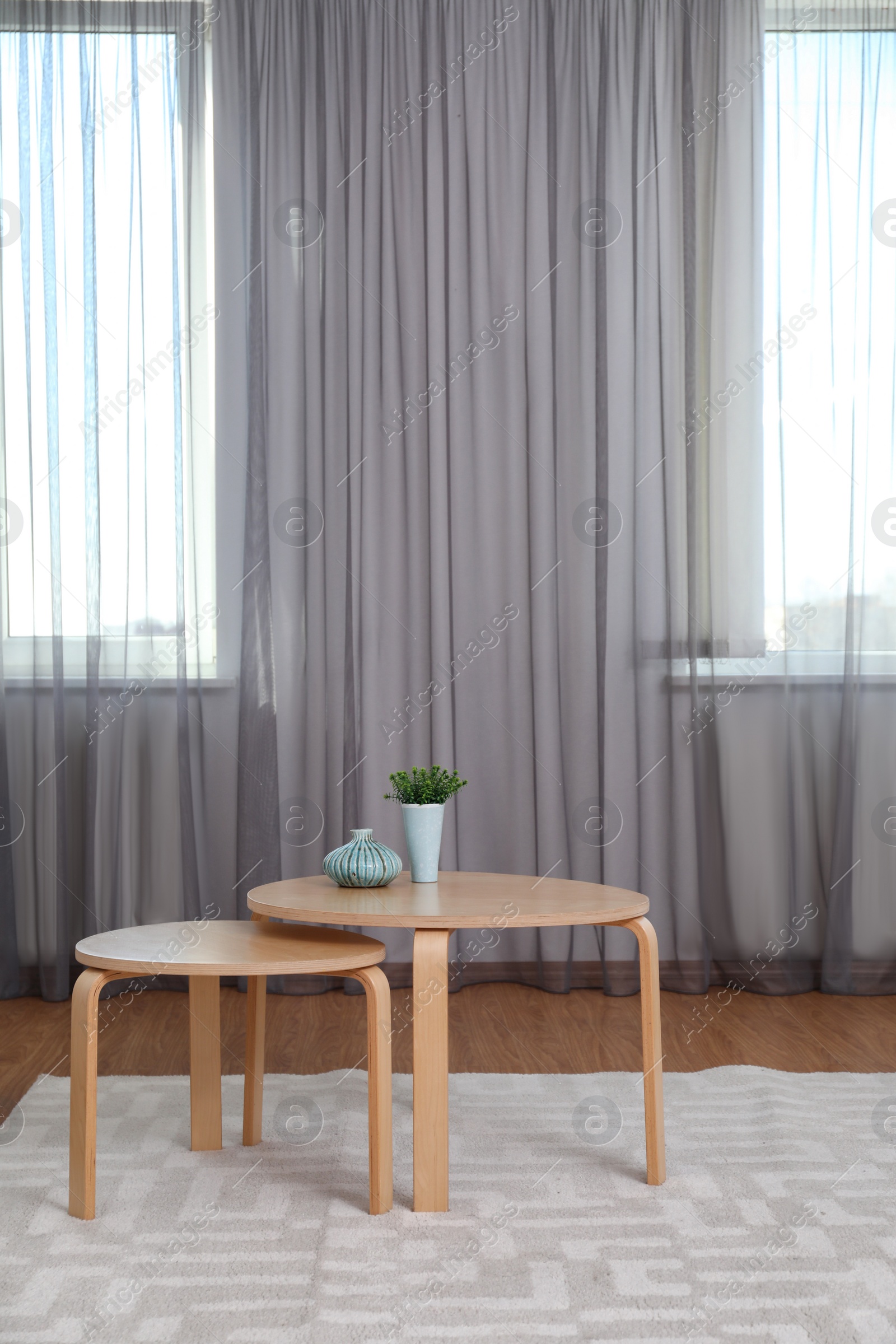 Photo of Windows with stylish curtains in living room interior