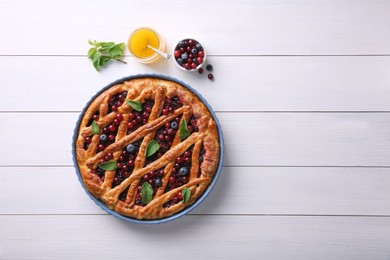 Photo of Delicious currant pie, honey and fresh berries on white wooden table, flat lay. Space for text