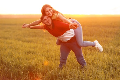 Photo of Happy young couple in green field on sunny spring day