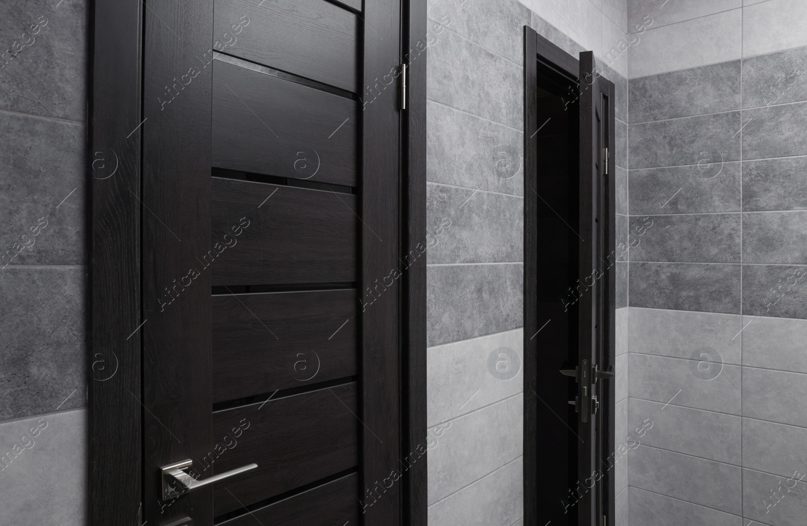 Photo of Public toilet interior with stylish doors and tiles