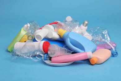 Photo of Pile of plastic garbage on light blue background