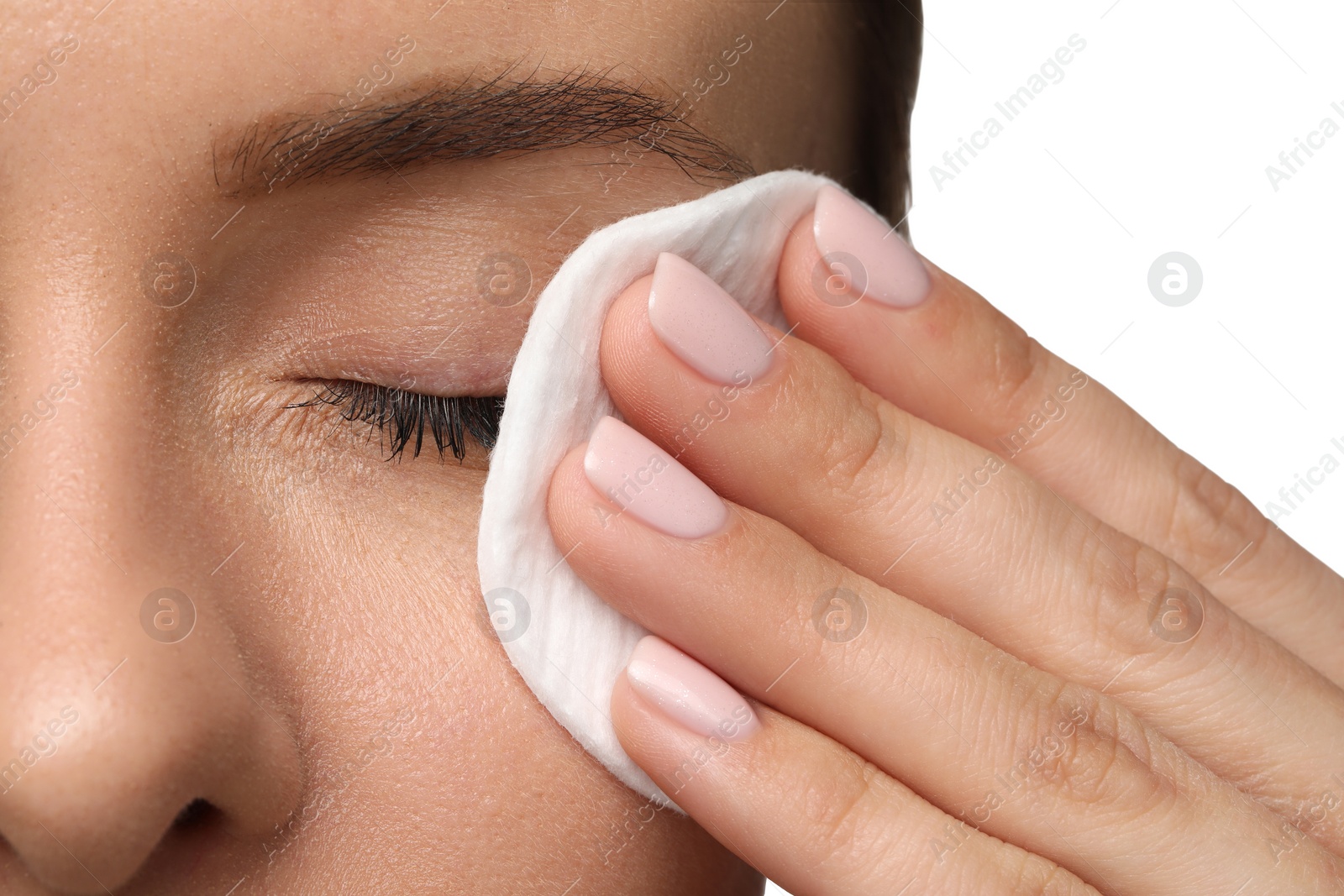 Photo of Woman removing makeup with cotton pad on white background, closeup