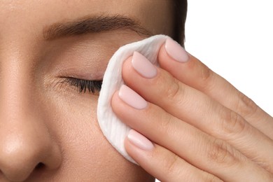 Woman removing makeup with cotton pad on white background, closeup