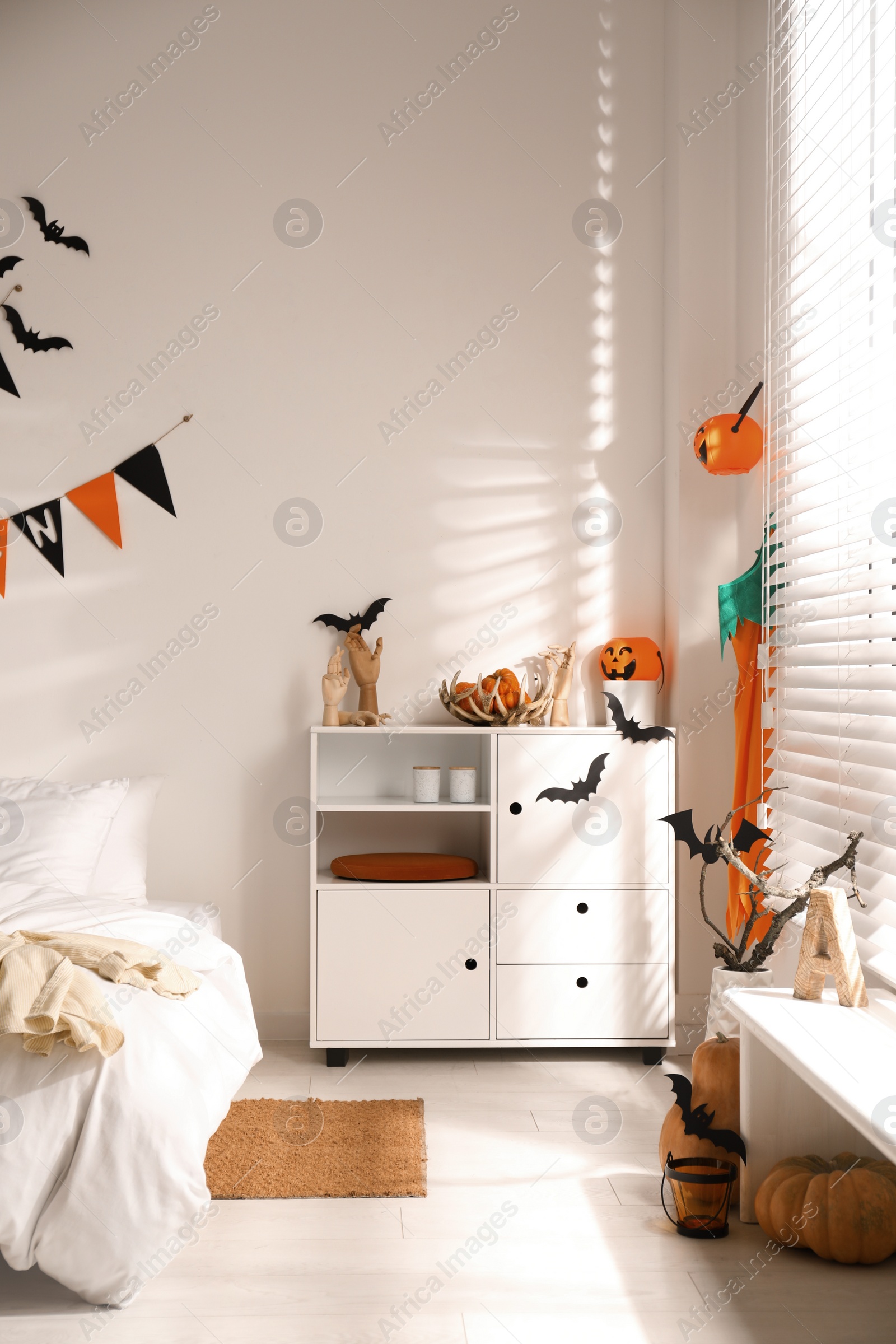 Photo of Stylish bedroom interior with festive Halloween decor